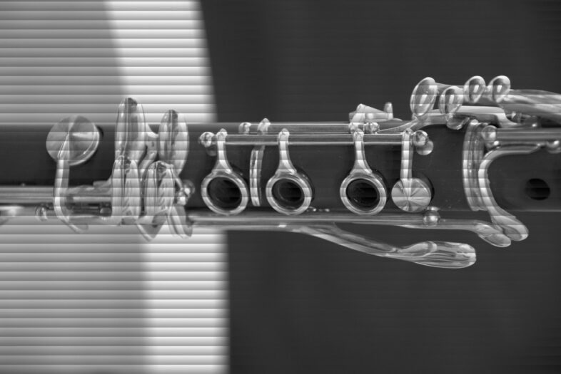 The silver keywork of a black clarinet