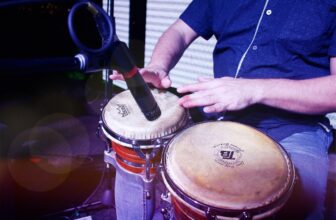 Close view of a percussionist playing a pair of bongos on stage