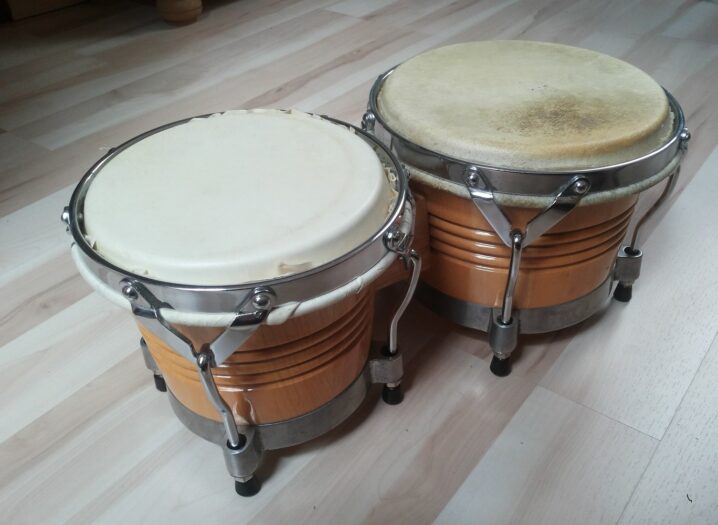 A connected pair of Cuban wooden bongos with metal tension hardware